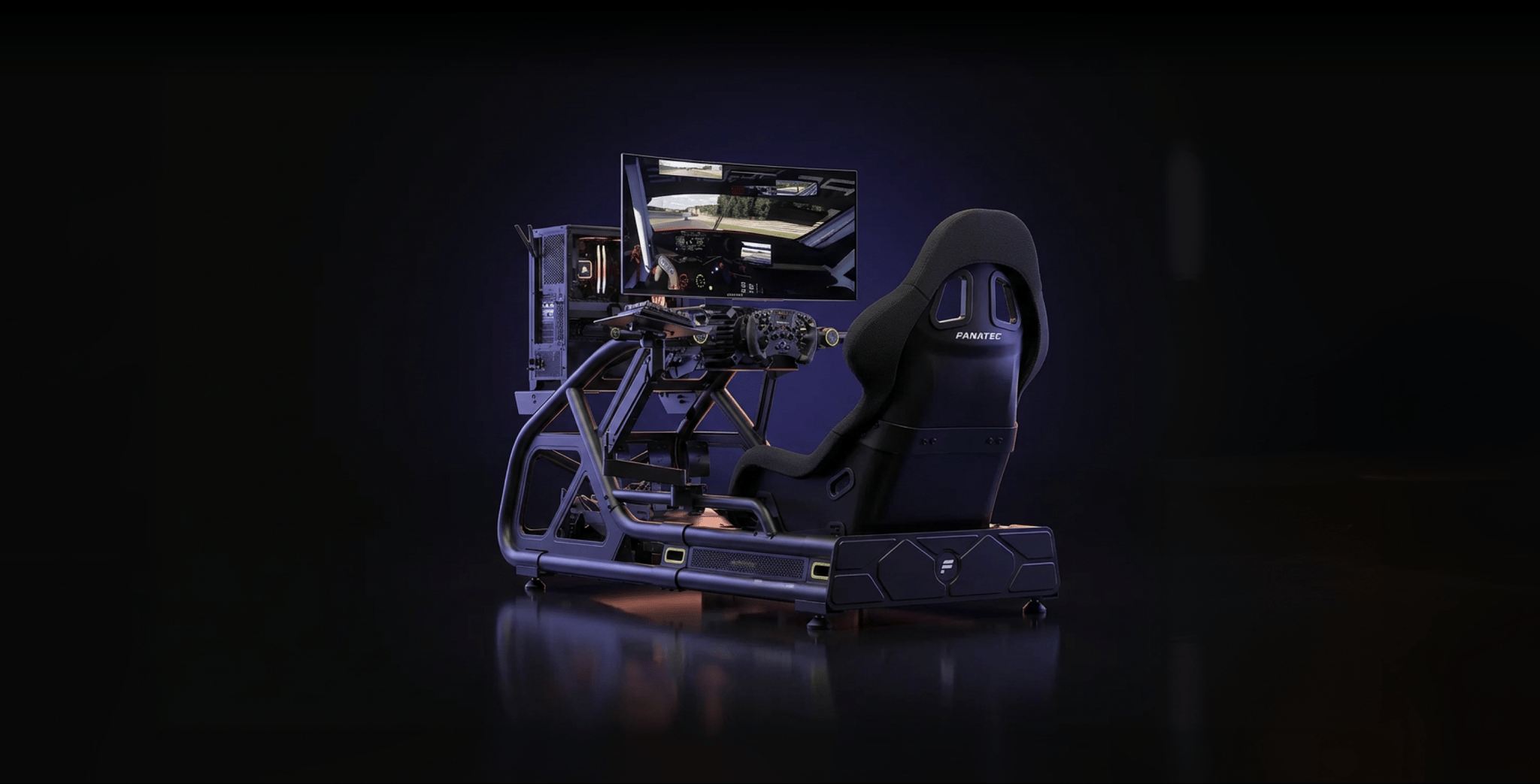 Sim racing rig with wheel, pedals, monitor, and PC