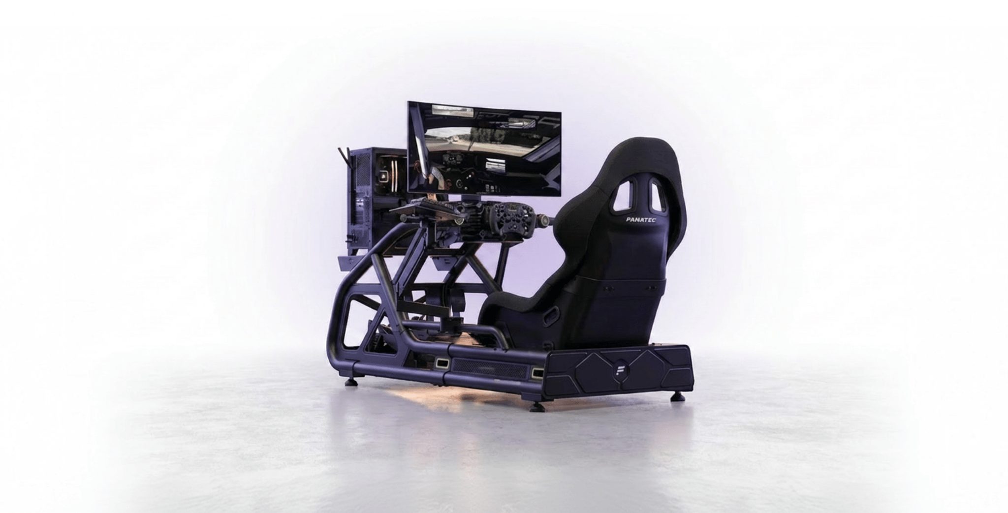 Sim racing rig with wheel, pedals, monitor, and PC