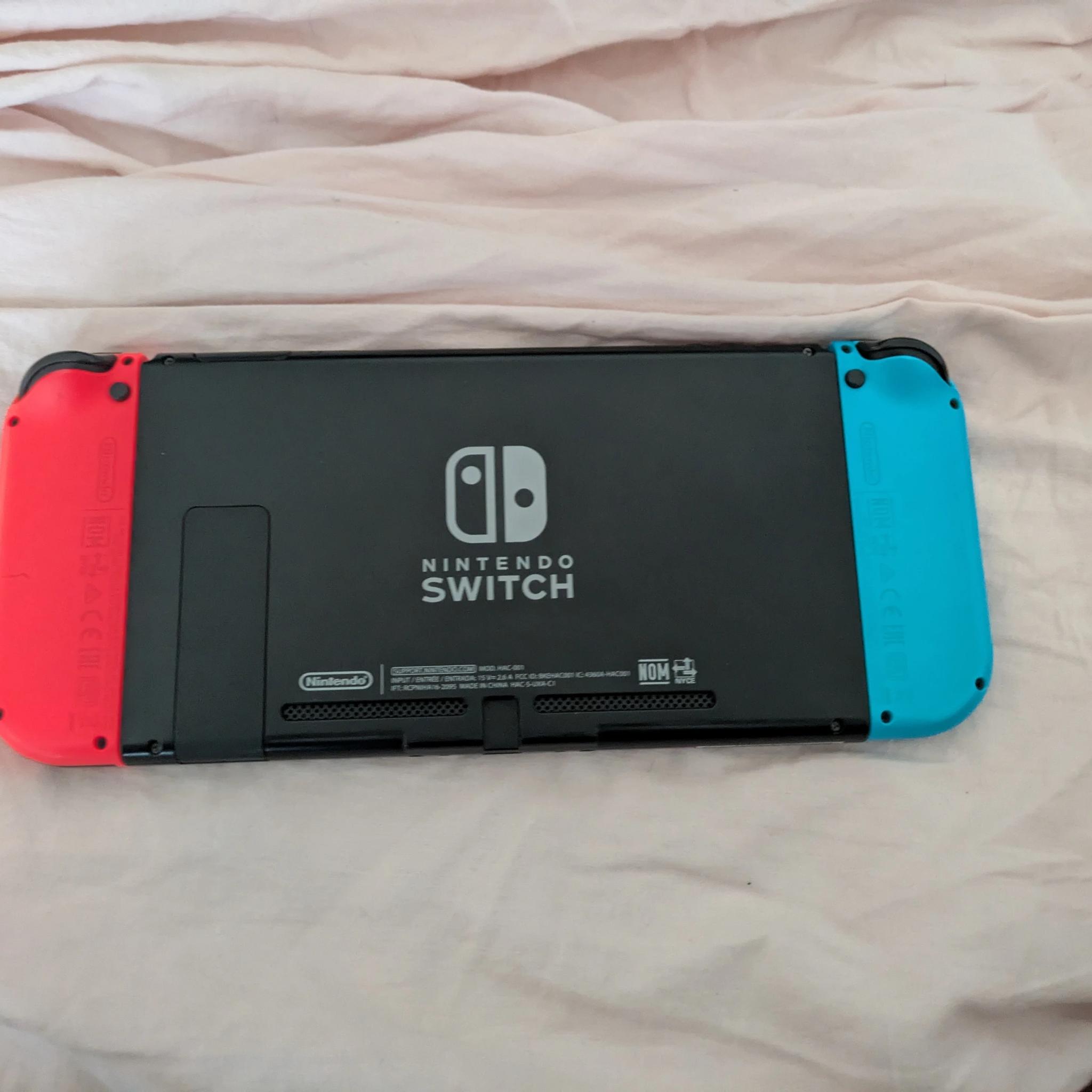 Nintendo Switch with Dock, Charger and controller base with 128GB SD card
