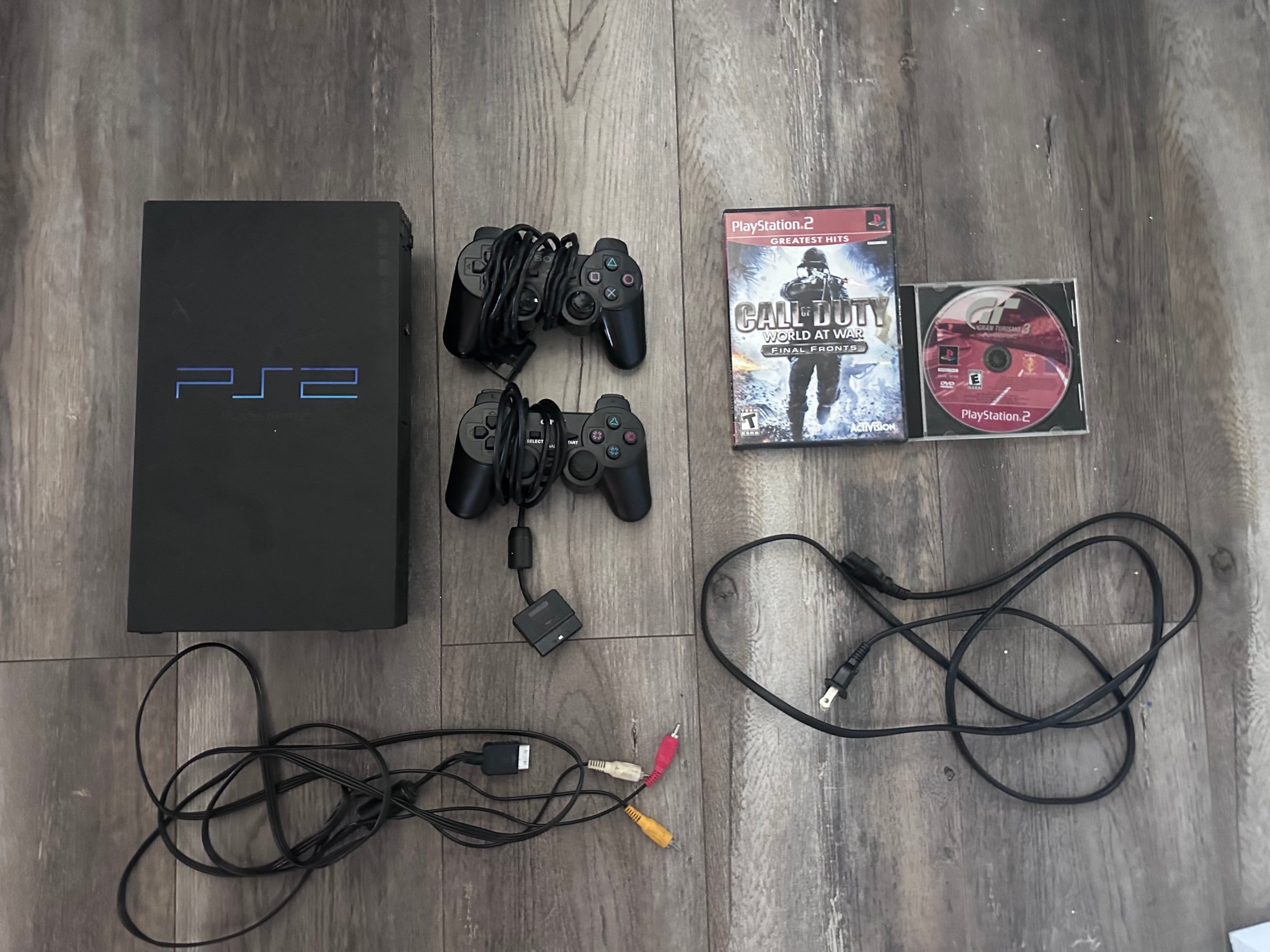 PlayStation 2 with 2 controllers, 2 games, and original cables (FULLY FUNCTIONAL)