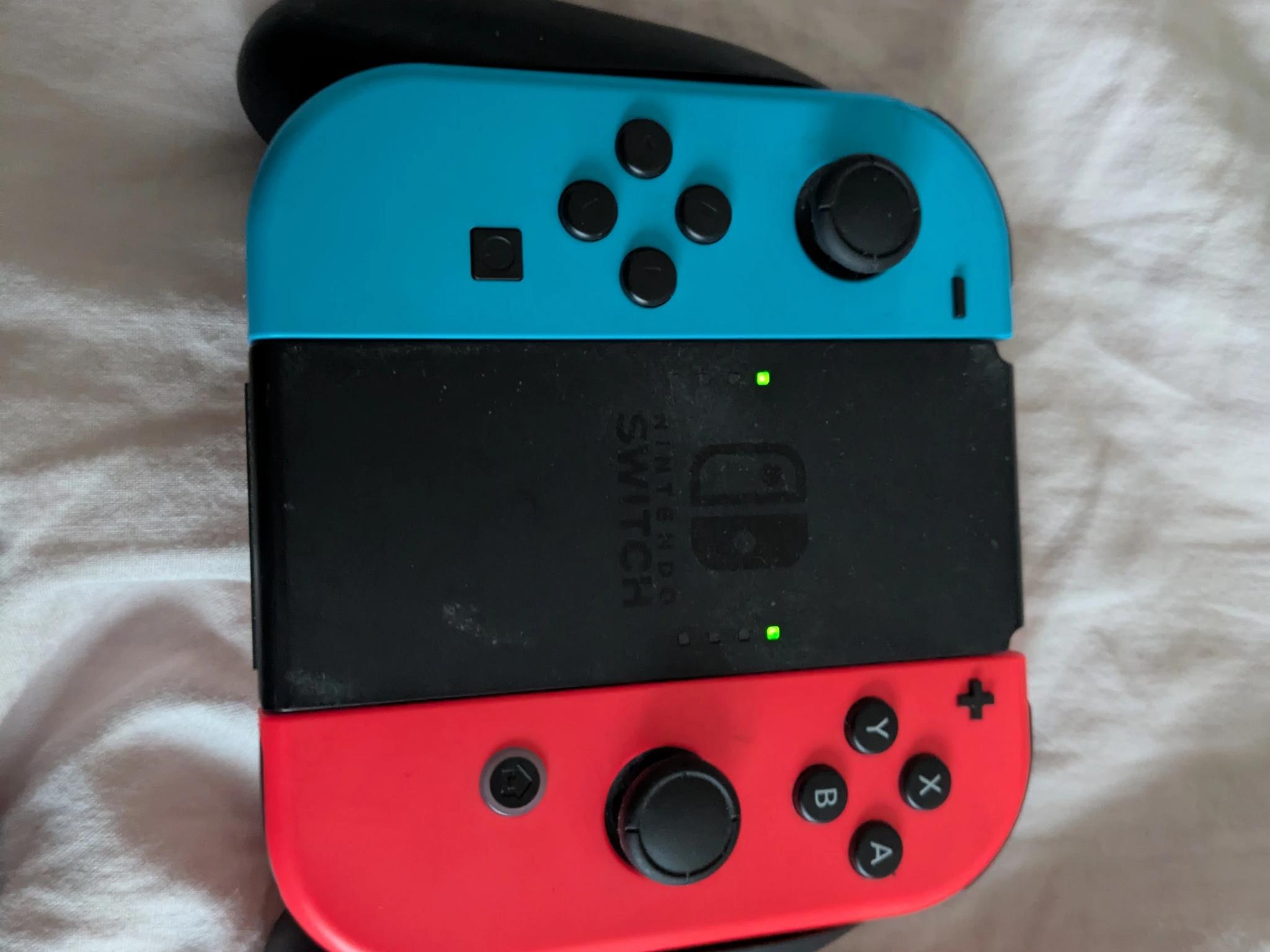 Nintendo Switch with Dock, Charger and controller base with 128GB SD card