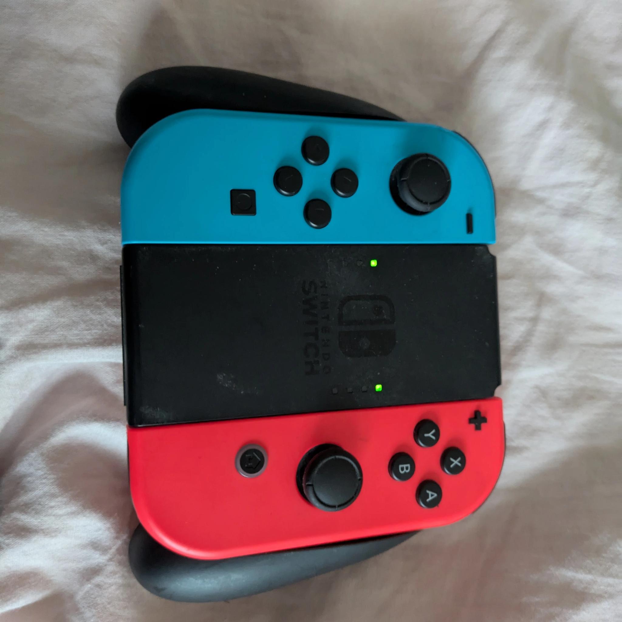 Nintendo Switch with Dock, Charger and controller base with 128GB SD card