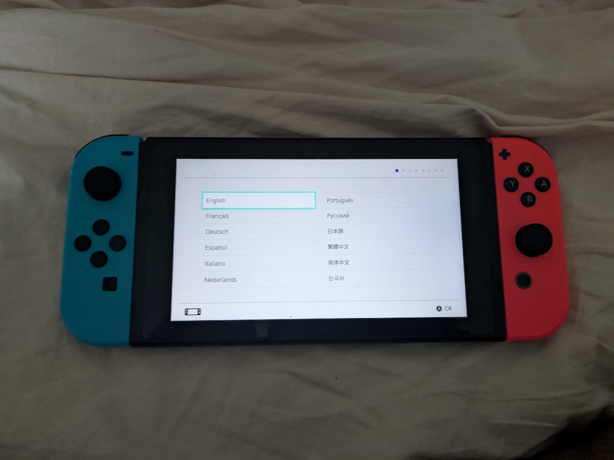 Nintendo Switch with Dock, Charger and controller base with 128GB SD card