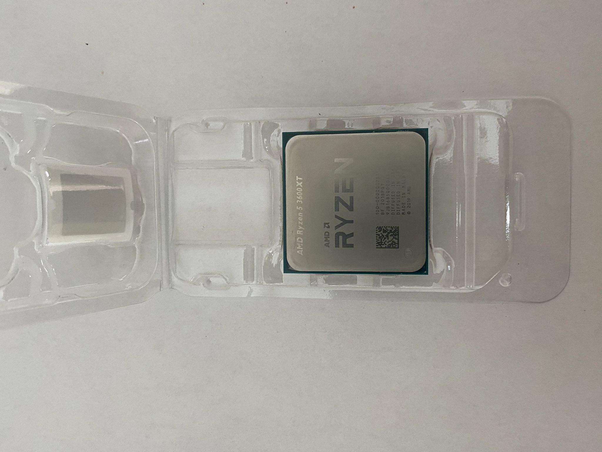 AMD Ryzen 5 3600XT 3.8 GHz 6-Core Processor and AMD Cooler in box.