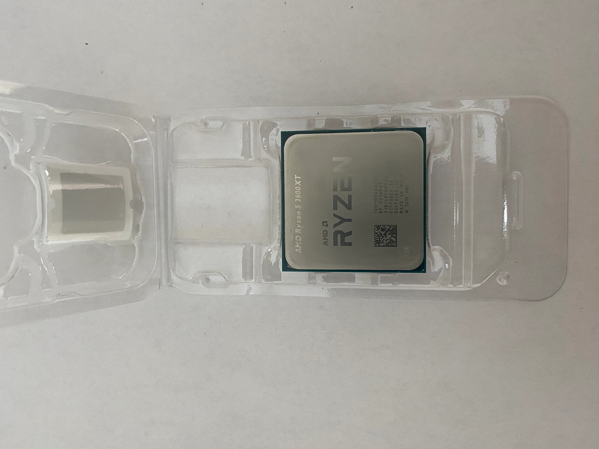 AMD Ryzen 5 3600XT 3.8 GHz 6-Core Processor and AMD Cooler in box.