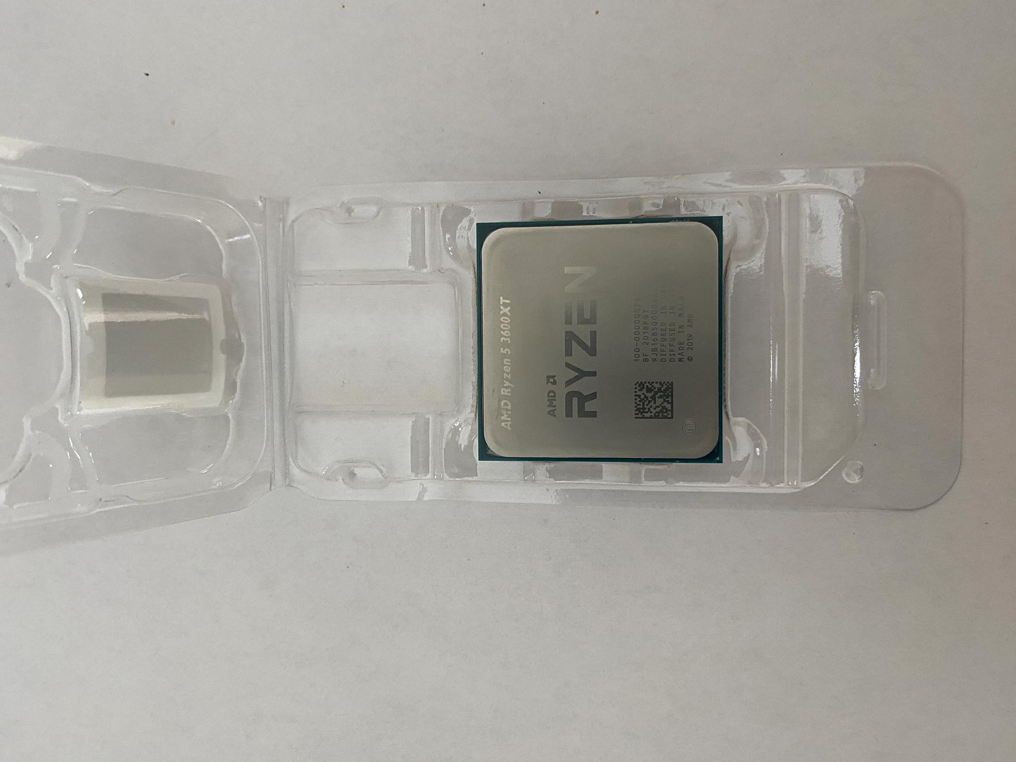 AMD Ryzen 5 3600XT 3.8 GHz 6-Core Processor and AMD Cooler in box.