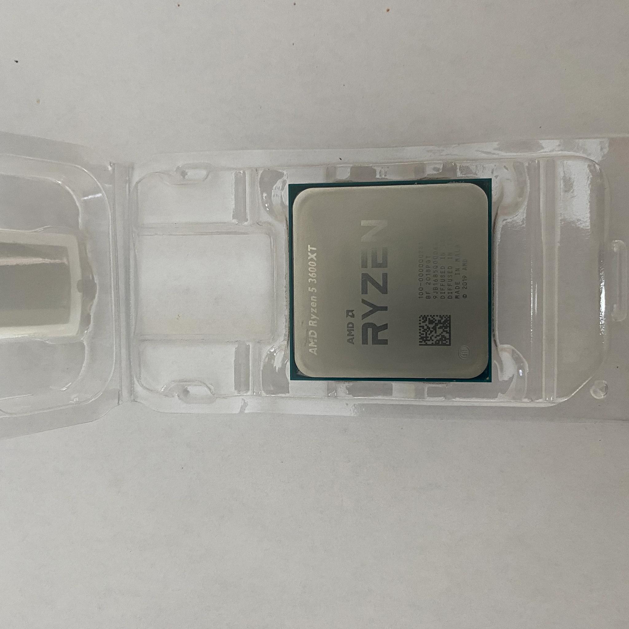 AMD Ryzen 5 3600XT 3.8 GHz 6-Core Processor and AMD Cooler in box.